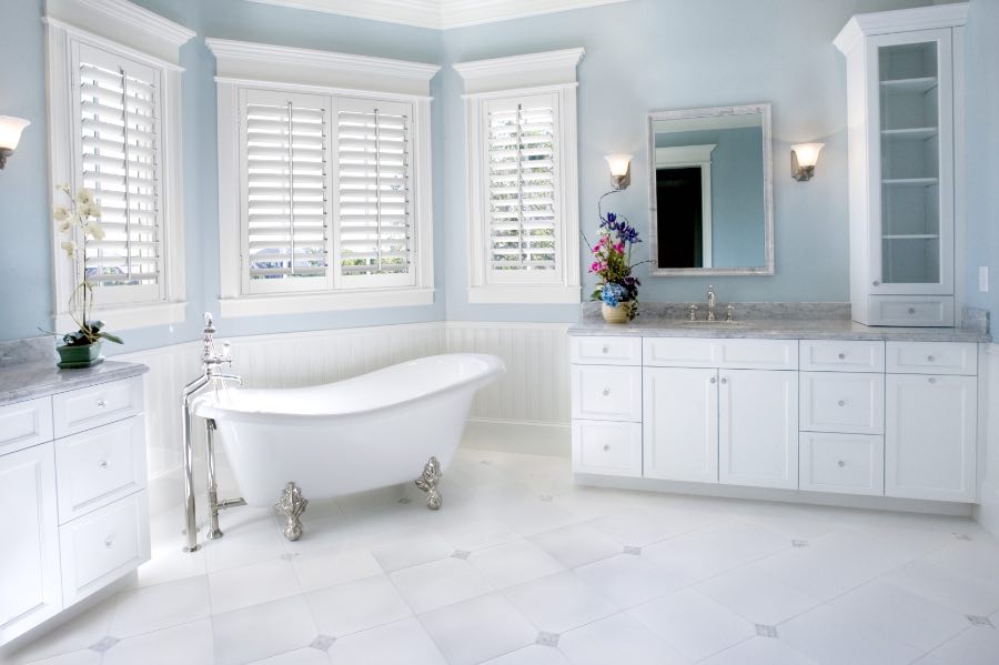 Bright, neutral-colored bathroom with free-standing tub.